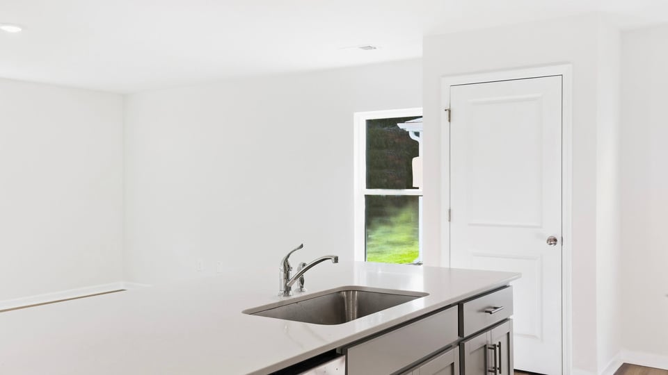 Kitchen and island with quartz countertops.