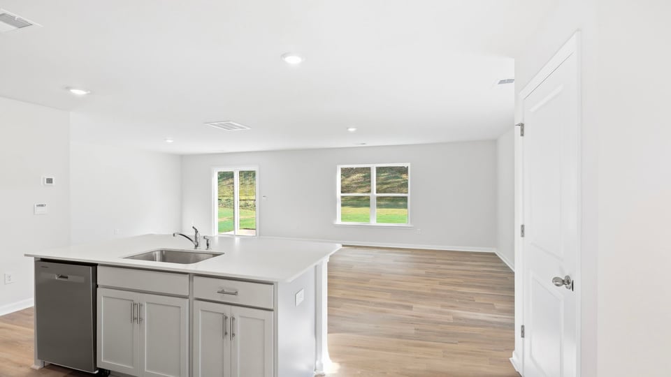 Kitchen and island with quartz countertops.