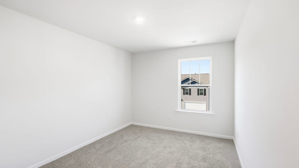 Bedroom with carpet and window.