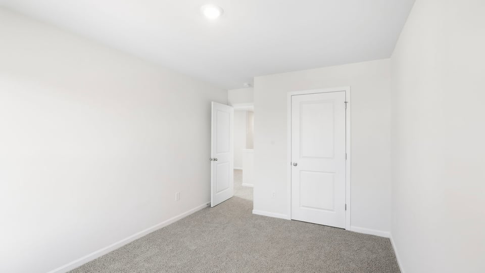 Bedroom with carpet and window.