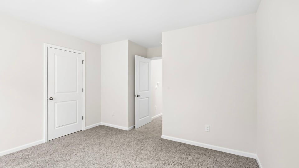 Bedroom with carpet and window.