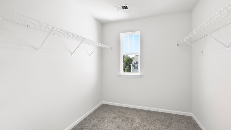 Closet with hanging storage racks.