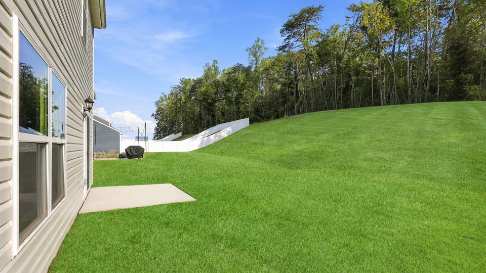 Back exterior of home with small patio.