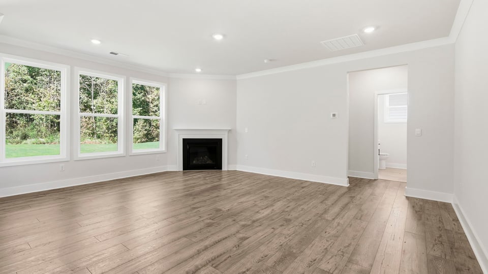 Living room with windows and fireplace.