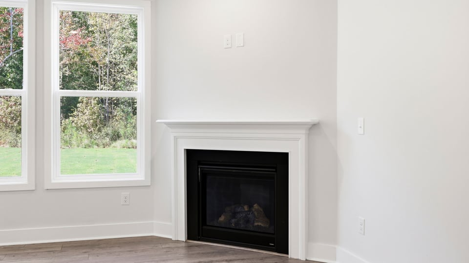 Living room with windows and fireplace.