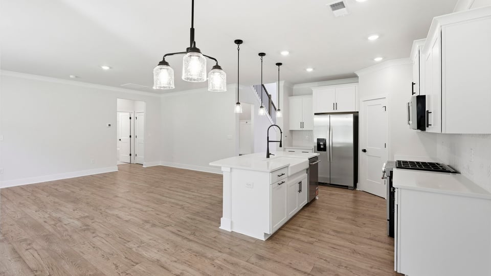 Kitchen and island with quartz countertops.