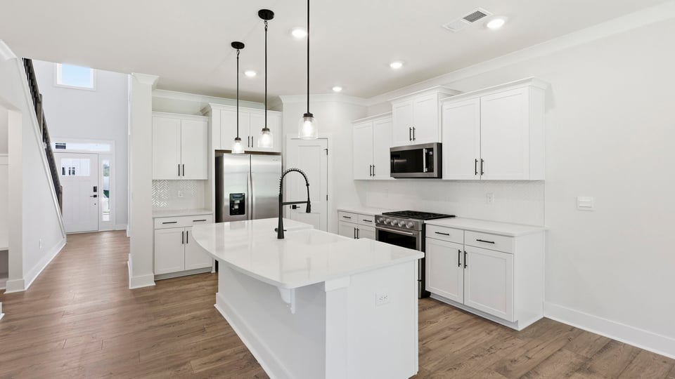 Kitchen and island with quartz countertops.