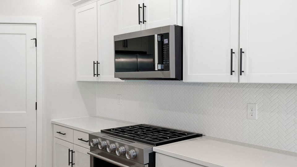 Kitchen and island with quartz countertops.