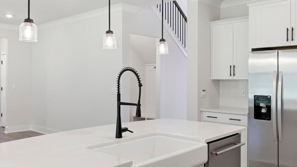 Kitchen and island with quartz countertops.