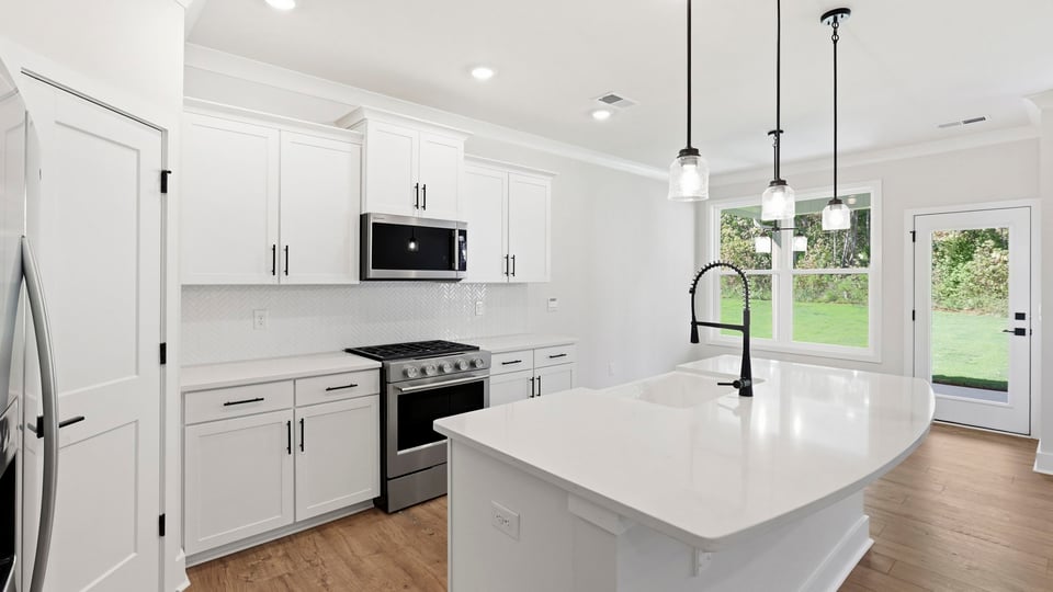 Kitchen and island with quartz countertops.