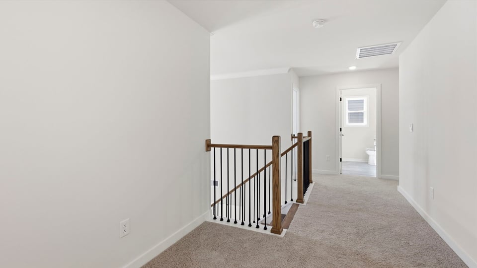 Loft area with carpet.