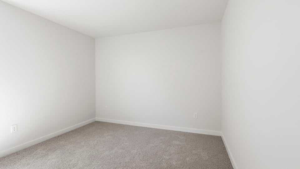 Bedroom with carpet and window.