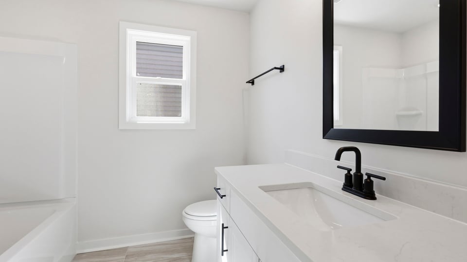 Bathroom with single vanity sink and bathtub.