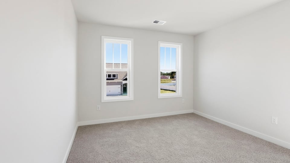 Bedroom with carpet and window.