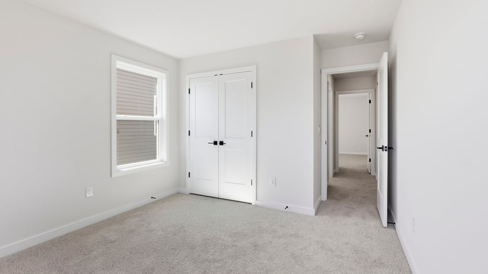 Bedroom with carpet and window.
