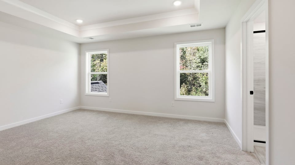 Bedroom with carpet and window.