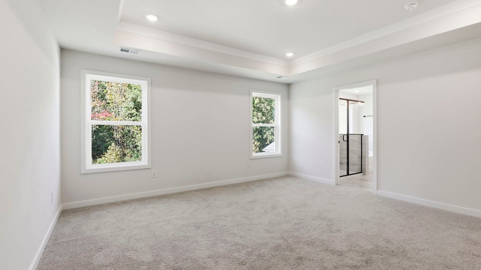 Bedroom with carpet and window.