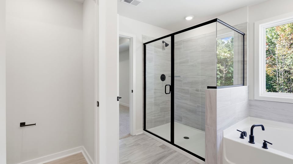 Bathroom with walk in shower and bathtub.
