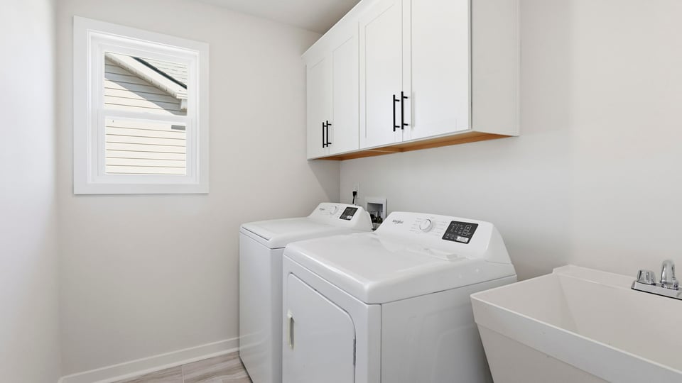 Laundry room with cabinets.
