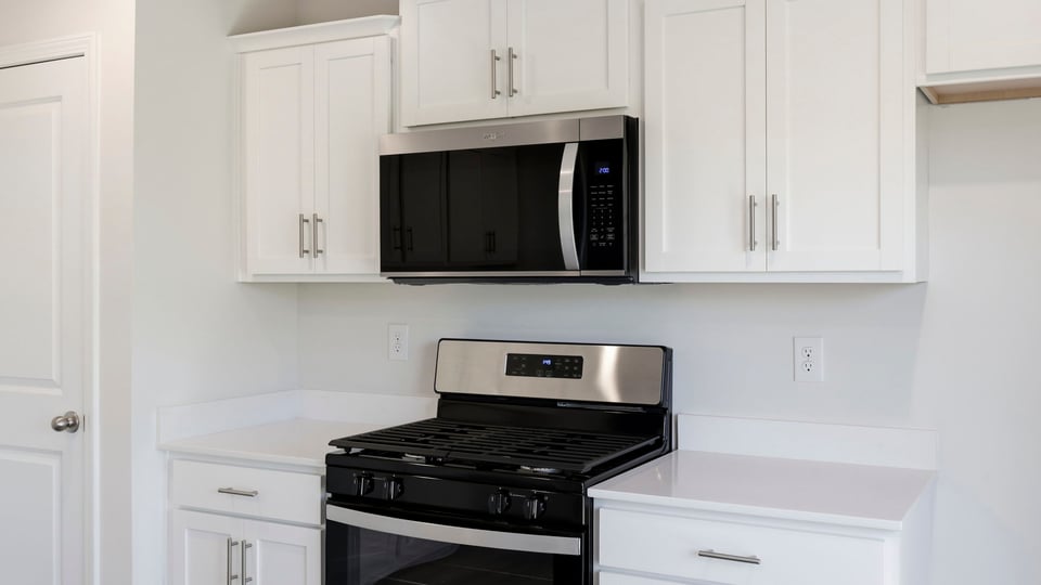 Kitchen and island with quartz countertops.