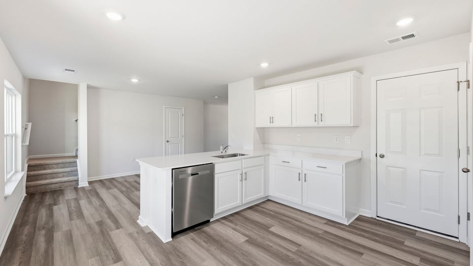 Kitchen and island with quartz countertops.