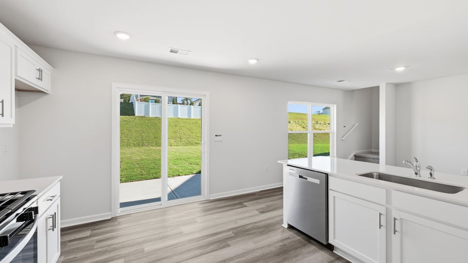 Kitchen and island with quartz countertops.