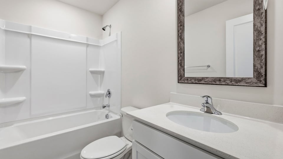 Bathroom with single vanity sink and bathtub.