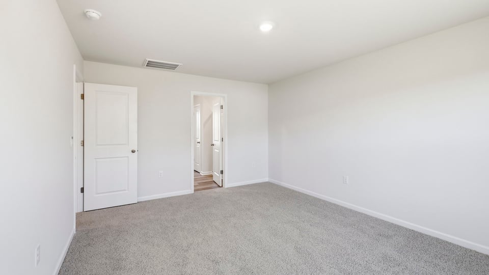 Bedroom with carpet and window.