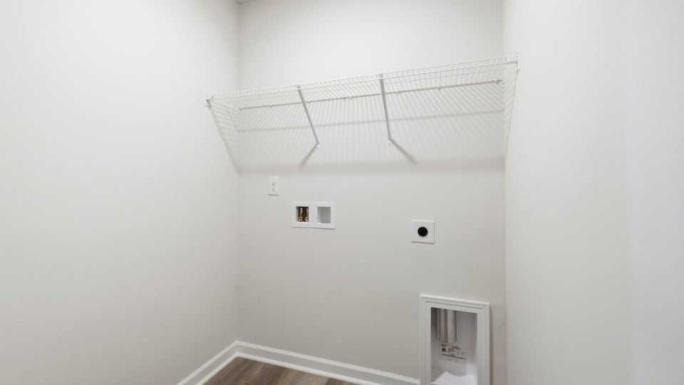 Laundry room with hanging storage racks.
