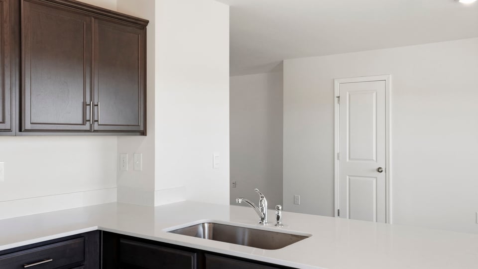 Kitchen with quartz countertops.