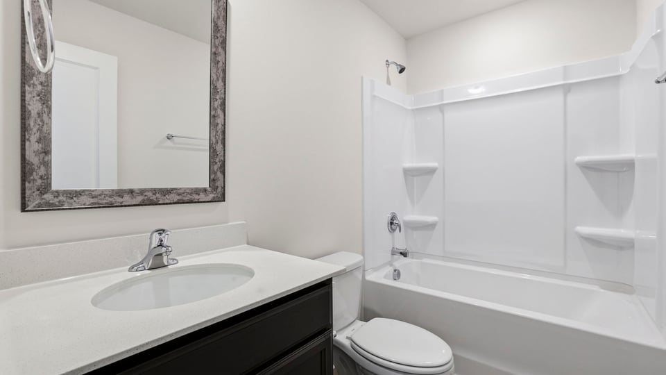 Bathroom with single vanity sink and bathtub.