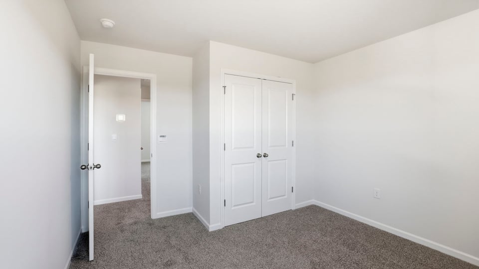 Bedroom with carpet and window.