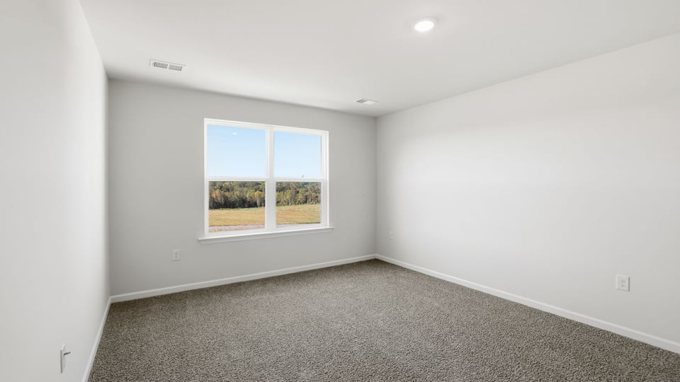 Bedroom with carpet and window.