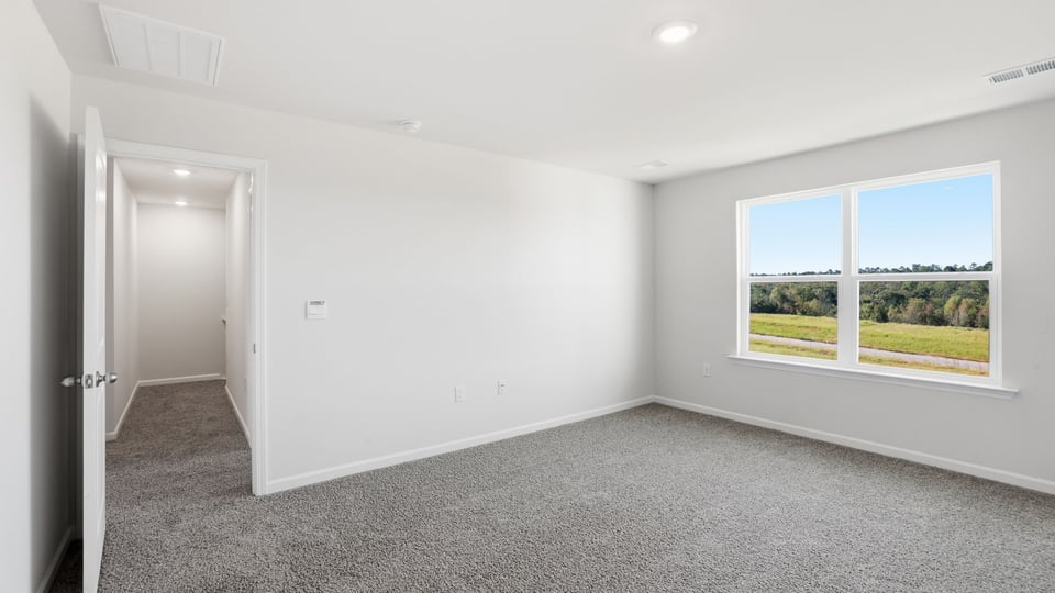Bedroom with carpet and window.