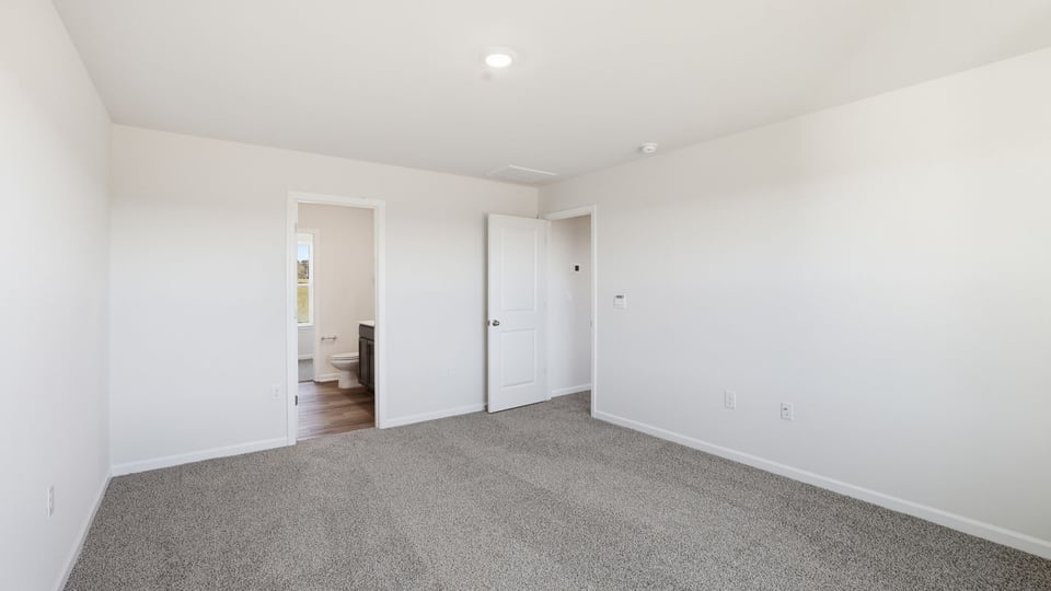 Bedroom with carpet and window.