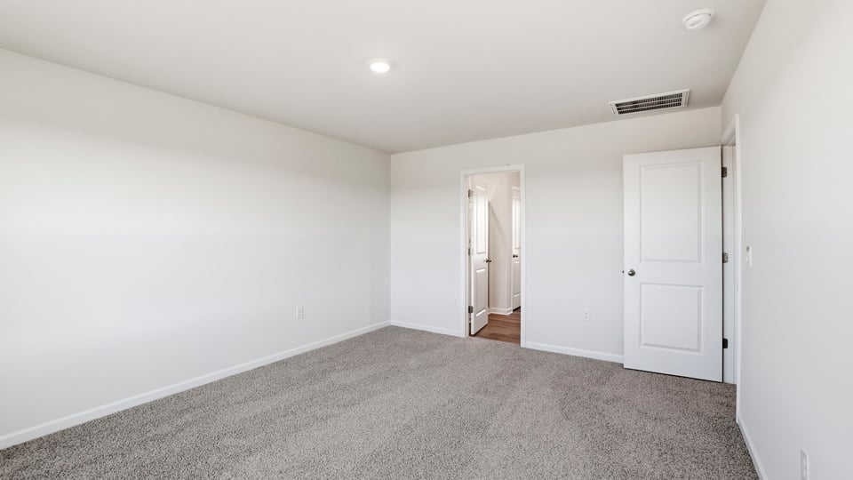 Bedroom with carpet and window.