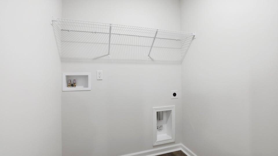 Laundry room with hanging storage racks.