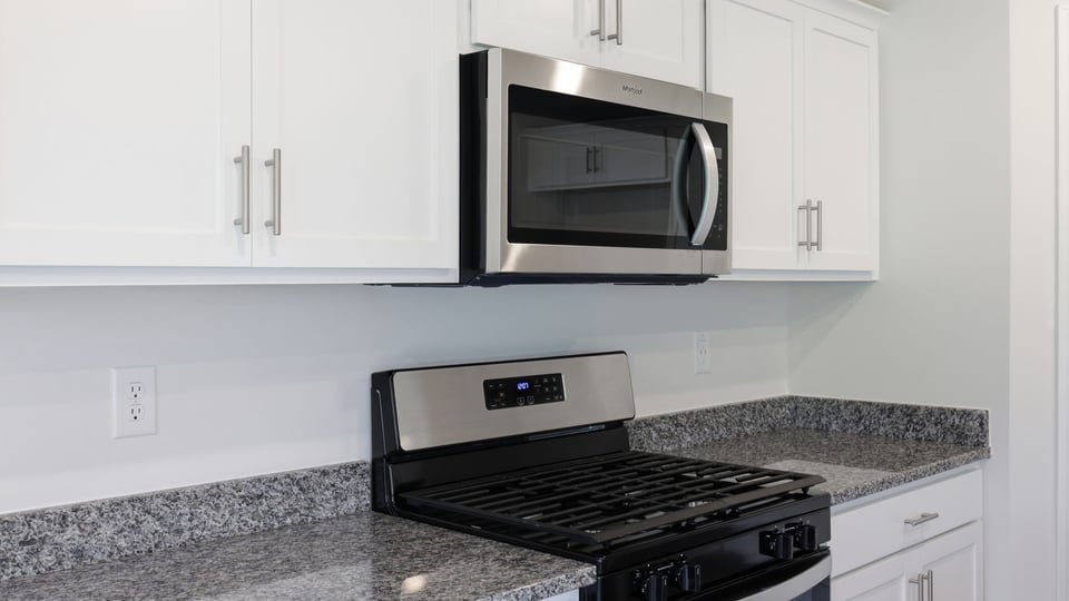 Kitchen and island with stainless steel appliances.