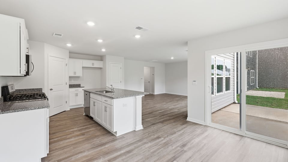 View of living room and kitchen.