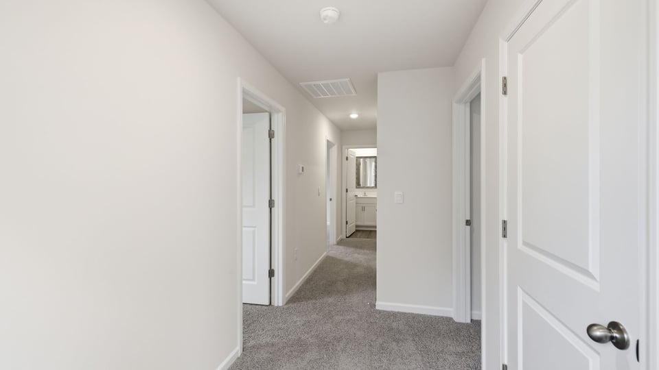 Hallway upstairs with carpet.