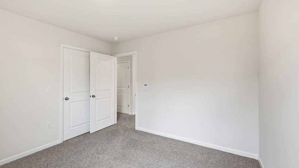Bedroom with carpet and window.