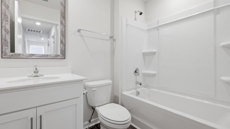 Bathroom with single vanity sink and bathtub.