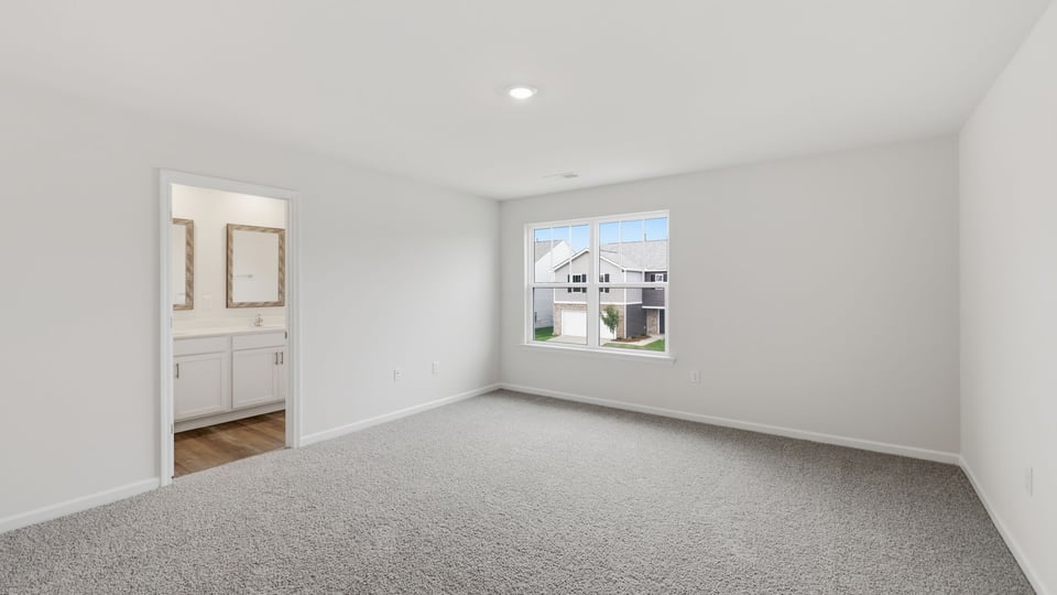 Bedroom with carpet and window.