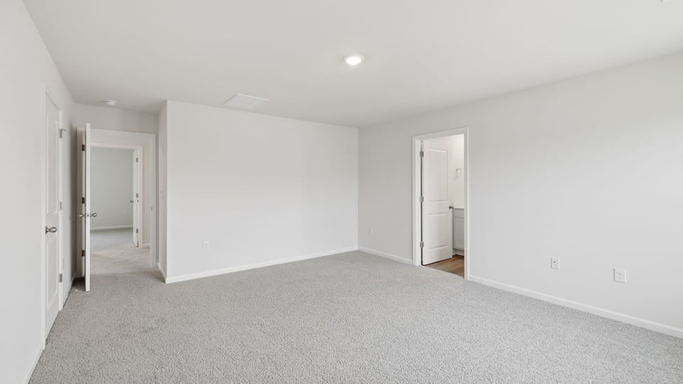 Bedroom with carpet and window.