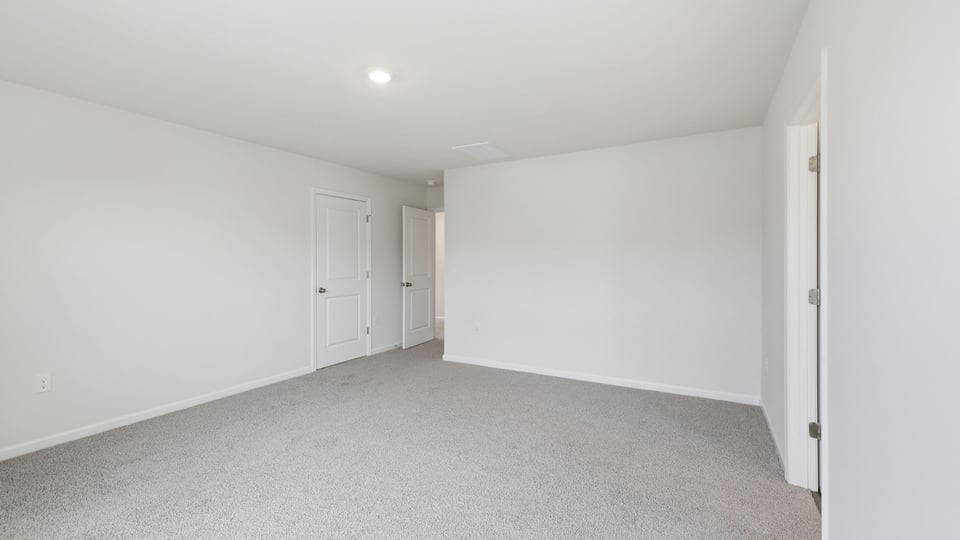 Bedroom with carpet and window.