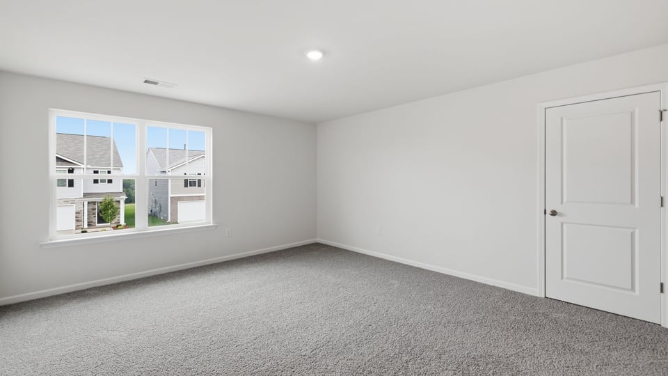 Bedroom with carpet and window.