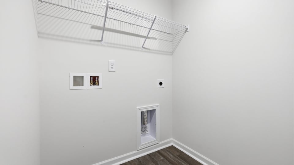 Laundry room with hanging storage racks.