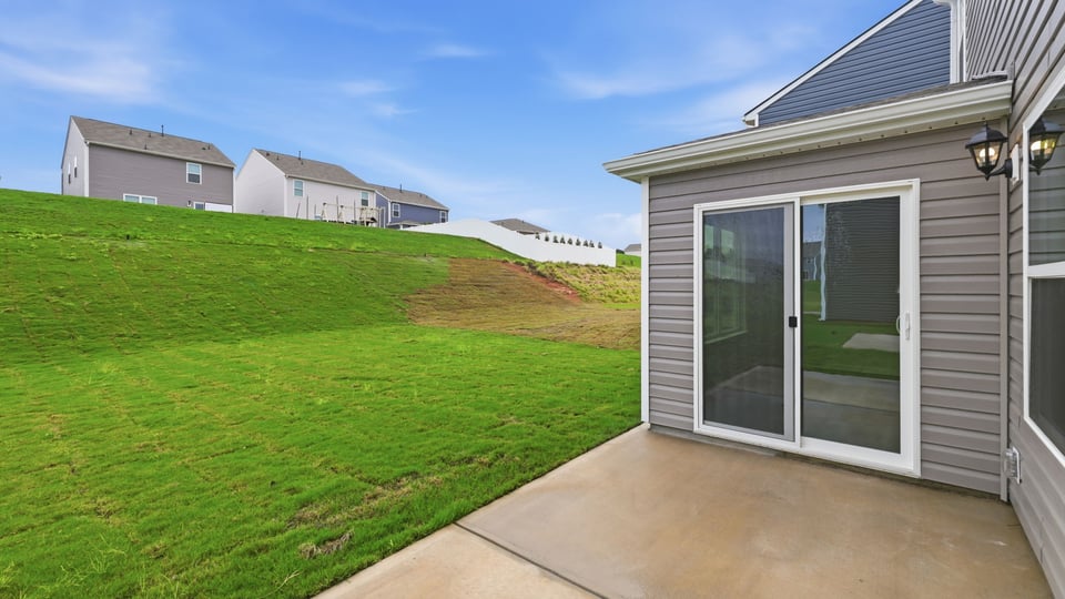Rear view of home with patio.