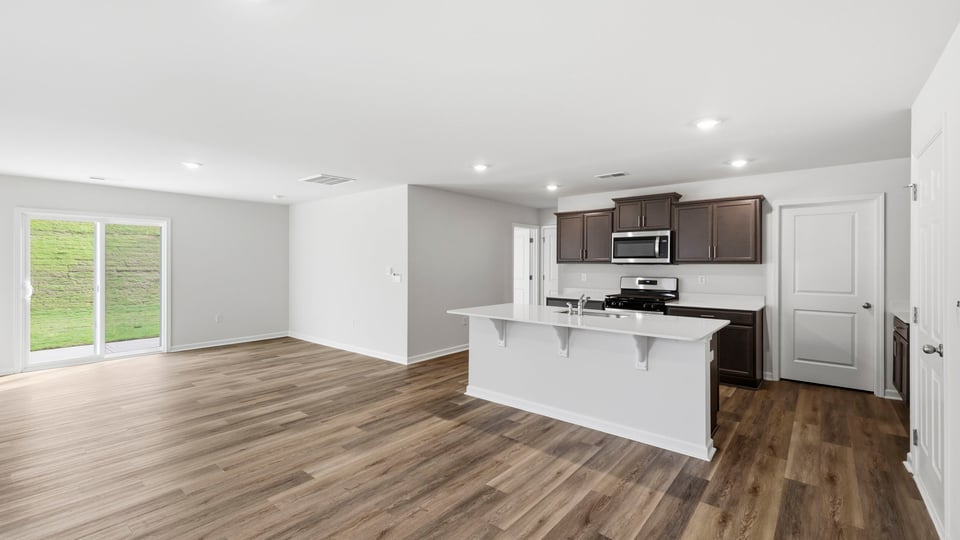 Kitchen and island with quartz countertops.