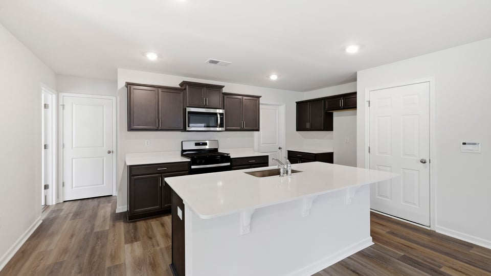 Kitchen and island with quartz countertops.